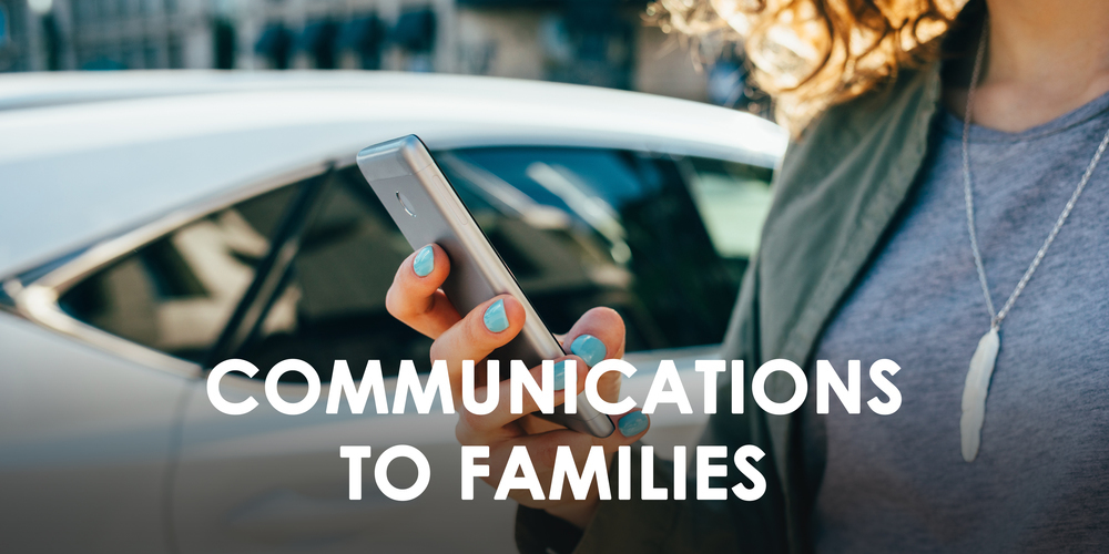 An image of a female holding and reading her mobile phone - Communications to Families