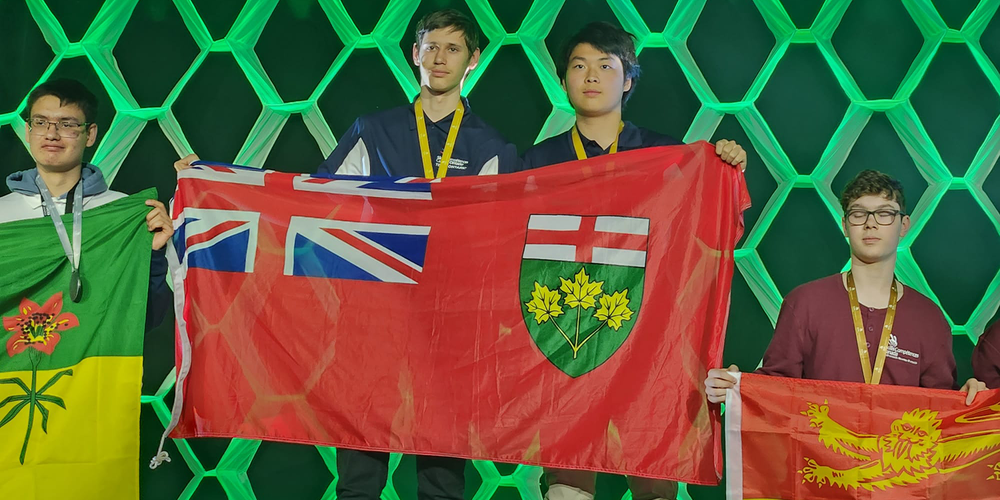 Banner - 4 students holding their respective provincial flags at the Skills Canada Nationals in Winnipeg   
