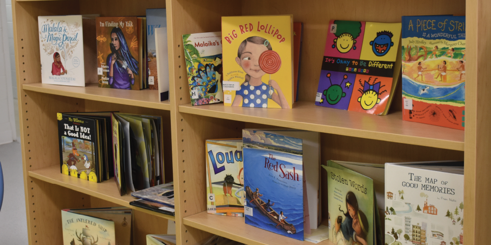 An image of a bookshelf full of children books.