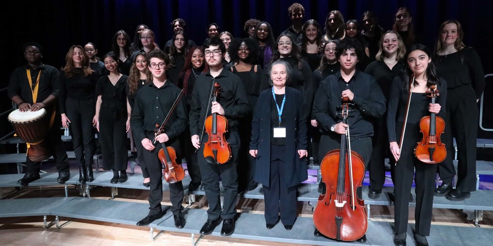 Group photo of the Father John Redmond Senior Choir posing with their instruments, along with their director Ms. Mirela Pilaf.
