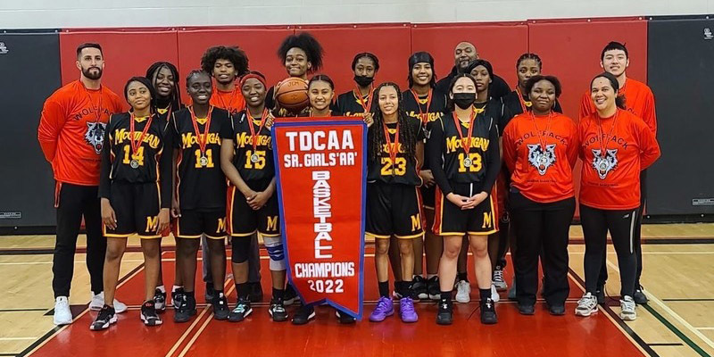 Banner  - JCMG girls basketball team with TDCAA Championship banner