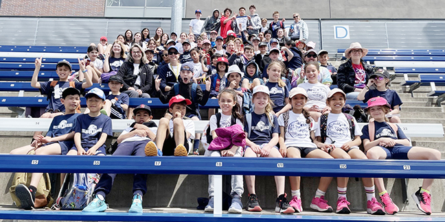 Banner: Photo of track and field athletes from St. John Catholic School on Kingston Road are shown at Varsity Stadium.