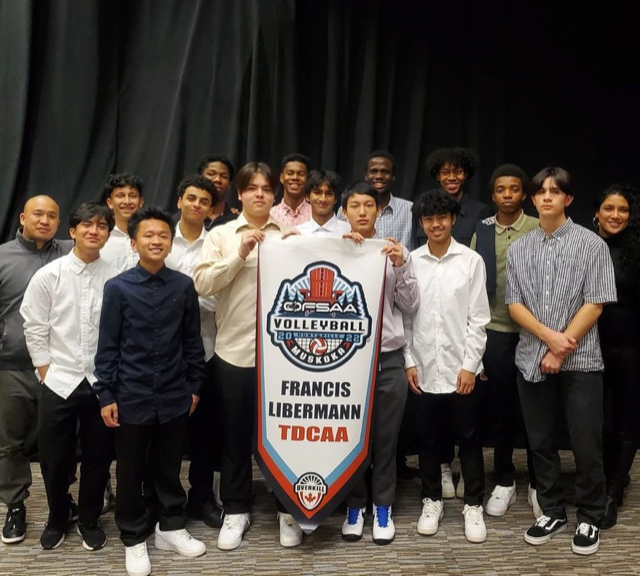 Francis Libermann Senior Boys Volleyball Team posing with Championship Banner