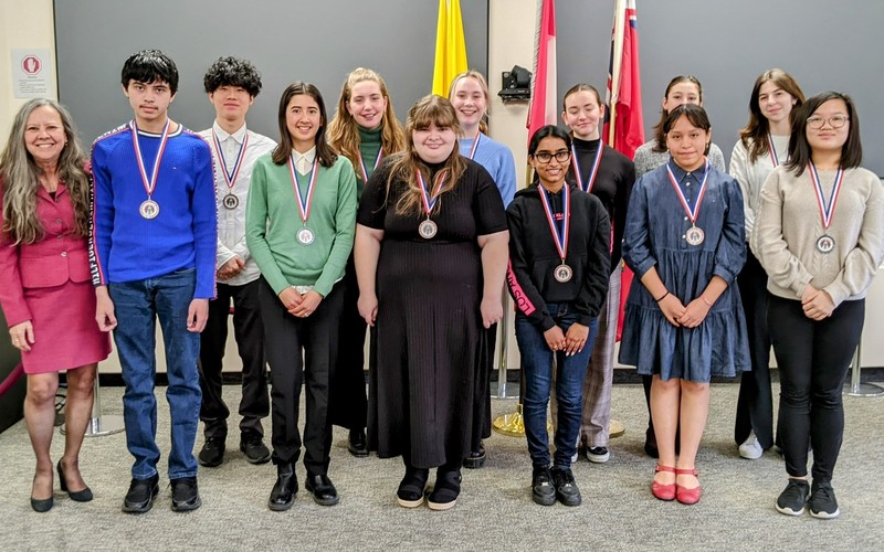 Winners of the Concours d'art Oratoire 2023 French Public Speaking Competition winners posing for a group photo with their medals