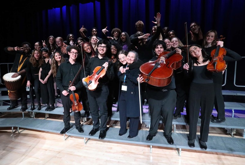 Group photo of the Father John Redmond Senior Choir posing with their instruments, along with their director Ms. Mirela Pilaf.