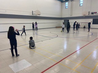 Photo of students playing soccer in the St. Marguerite Bourgeoys school gym at lunch.