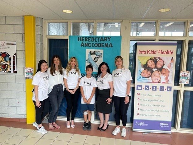 Group photo of St. Jane Frances students and staff in their white HAE Awareness t-shirts