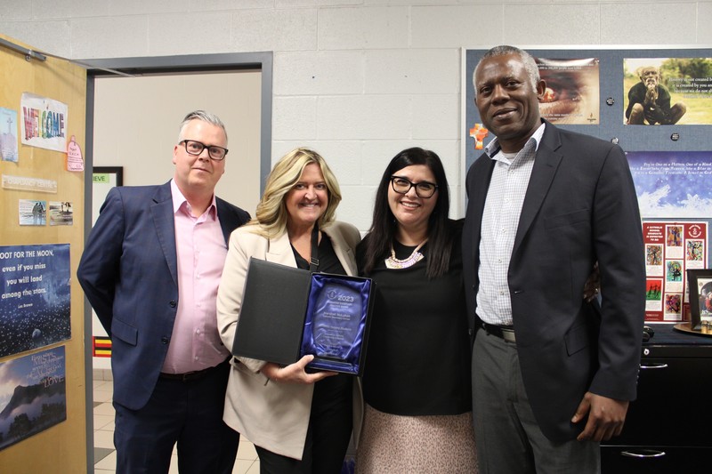 Photo of TCDSB Director of Education Brendan Browne, Executive Superintendent Shawna Campbell and Superintendent George Danfulani presenting the Innovative Exemplary Practice Award to Linda Izzo
