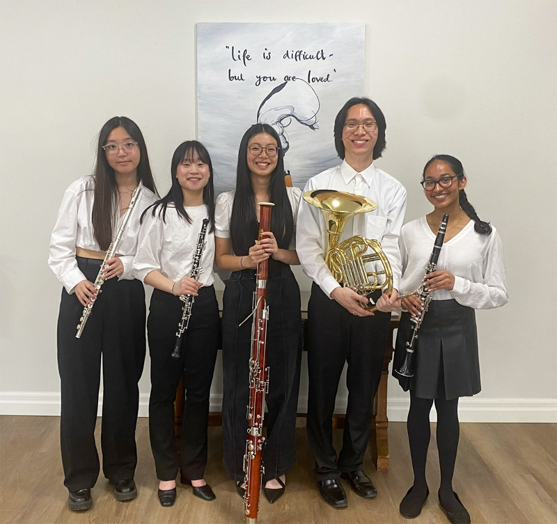 Group photo of the Cardinal Carter Senior Woodwind Quintet posing with their instruments