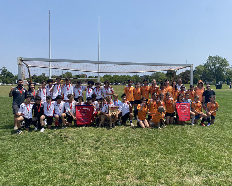 Group photo of both the St. Matthew boys team and St. Clement girls team on the soccer field