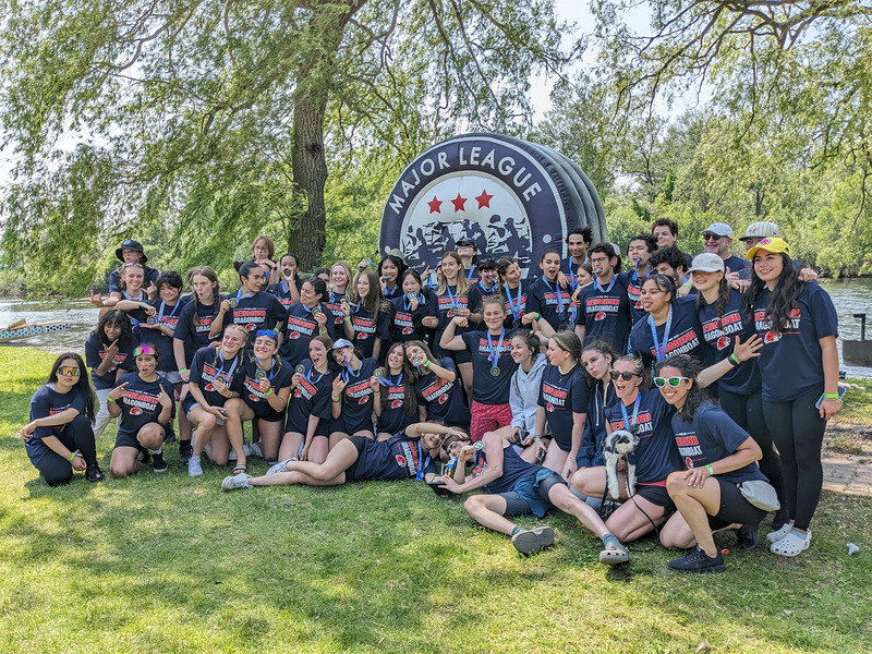 Group photo of FJR dragonboat team posing with their medals