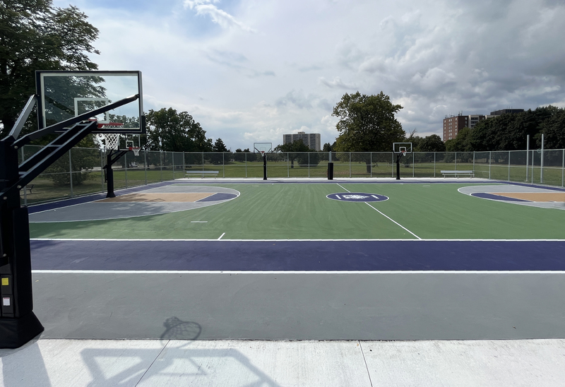 Side view photo of James Cardinal McGuigan Catholic High School's outdoor basketball court