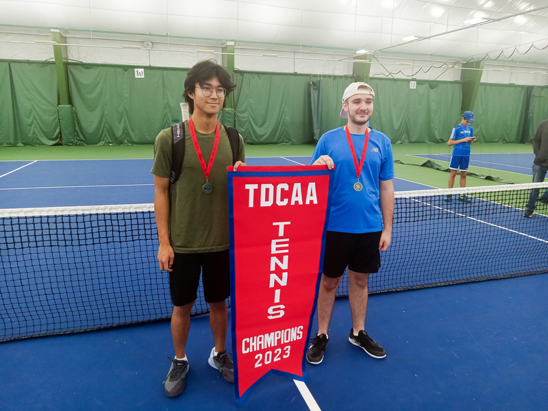 Boys Doubles team of Michael C. and Victor G. with their TDCAA tennis championship banner